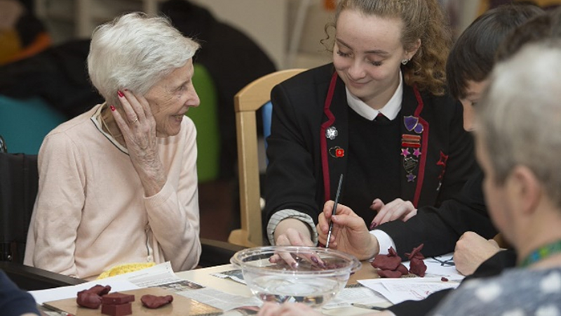 Whitburn academy pupil with woman from Whitdale Care Home