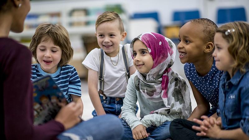 Group reading session with teacher and children