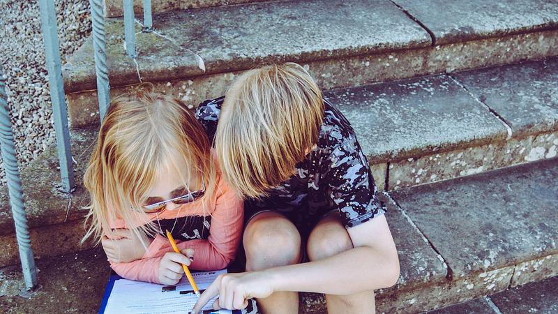 two children completing a learner attitude survey