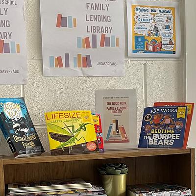 A shelf of books and a sign above that reads ' family lending library'