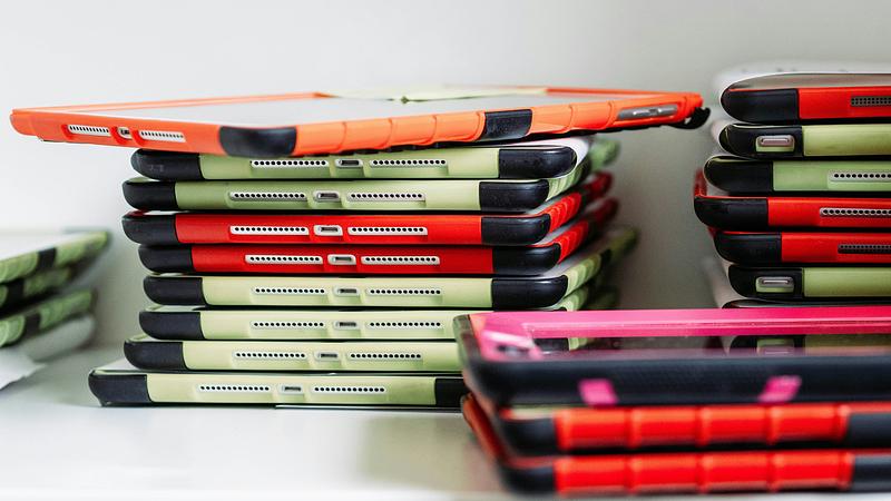 Piles of tablets with colourful cases