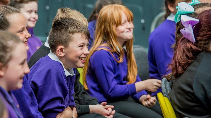 primary school pupils smiling and laughing